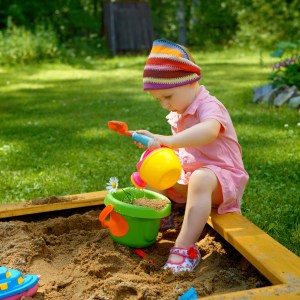 little girl playing in sandbox